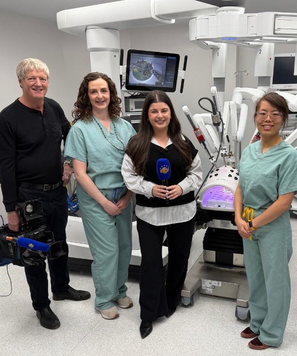 Left to right: Tony Barrington, NTV camera operator; Dr. Amanda Fowler; Beth Penney, NTV reporter; and Dr. Mo Yu Lanny Li, pictured with the robotic-assisted surgical system during a media feature on advancing surgical care in Newfoundland and Labrador.