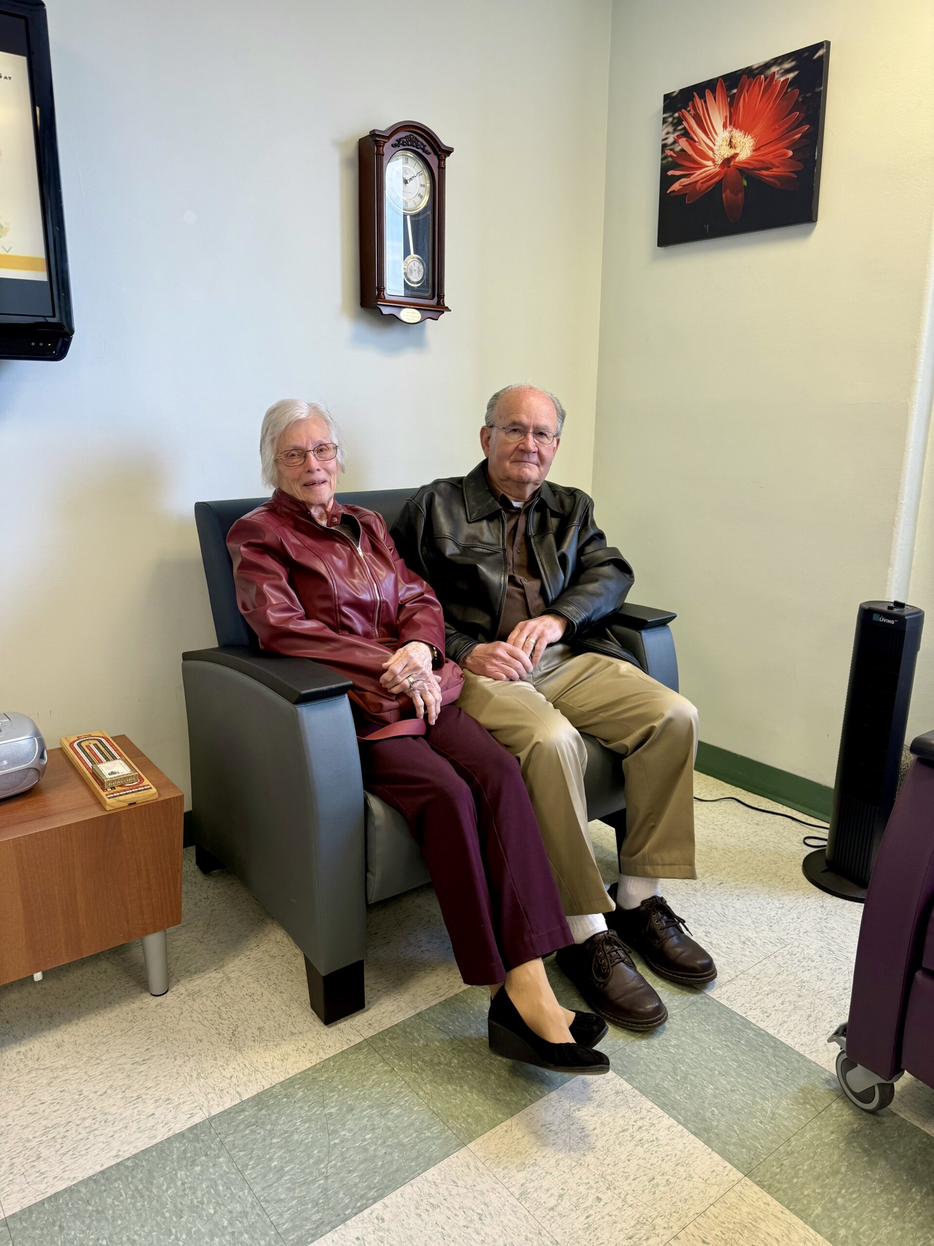 Older couple seated in a renovated palliative care family room