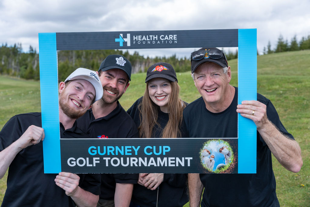 Golf team posing with a photo frame at the 2026 Gurney Cup Golf Tournament