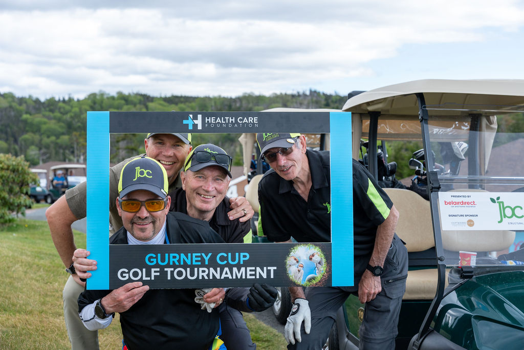 Golf team posing with a photo frame at the 2026 Gurney Cup Golf Tournament