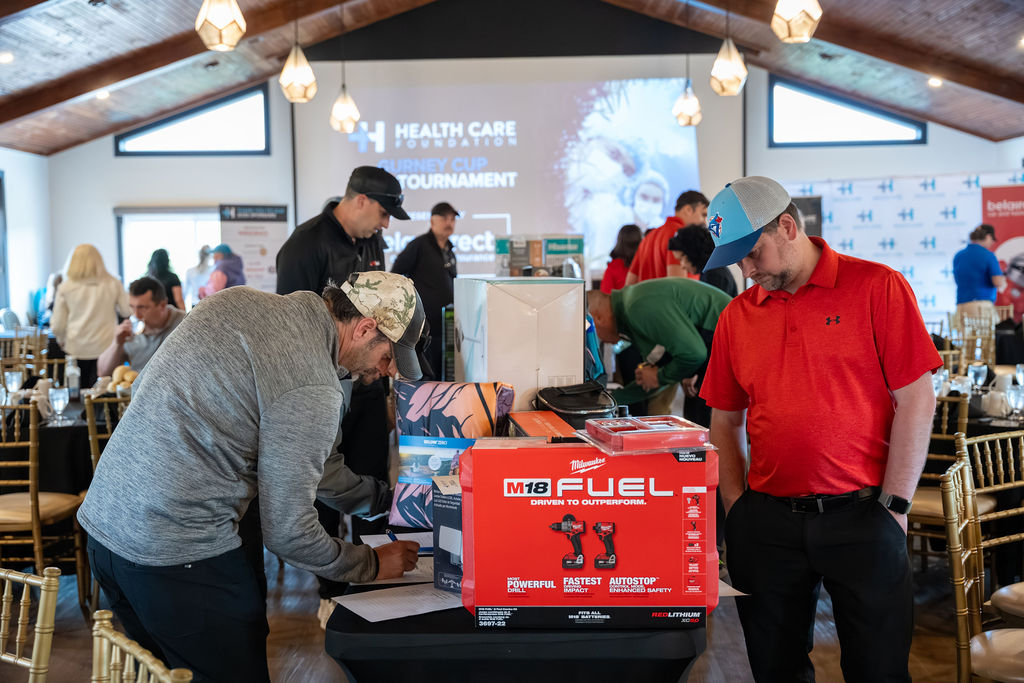 Participants browsing prizes at the 2026 Gurney Cup Golf Tournament