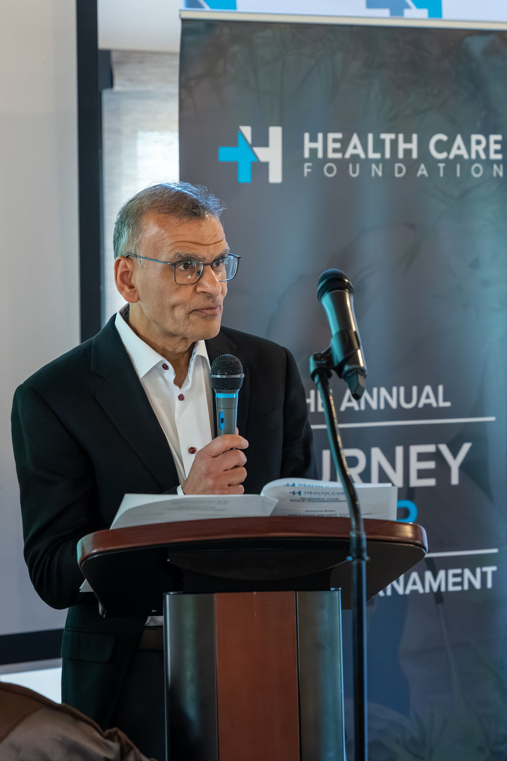 Speaker at the podium during the 2026 Gurney Cup Golf Tournament