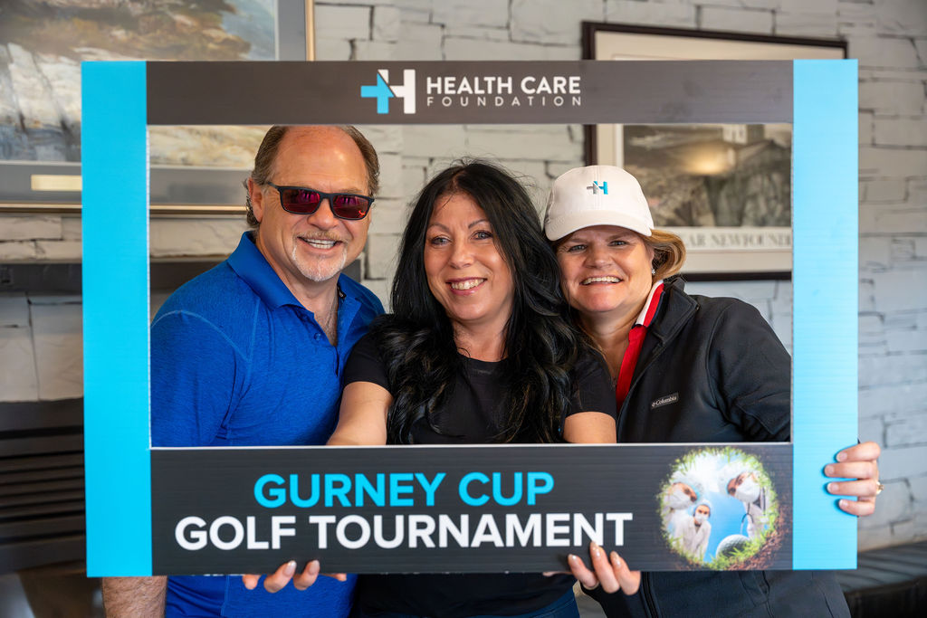 Golfers posing with a photo frame at the 2026 Gurney Cup Golf Tournament