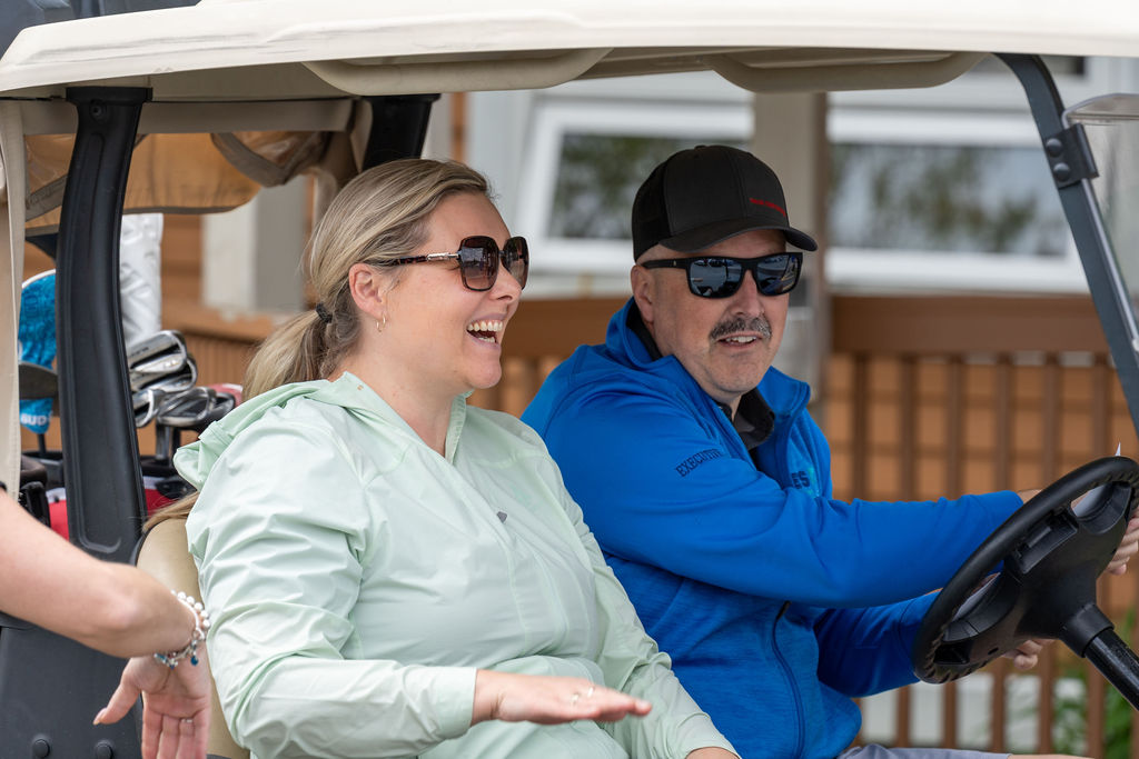 Golfers riding in a golf cart at the 2026 Gurney Cup Golf Tournament