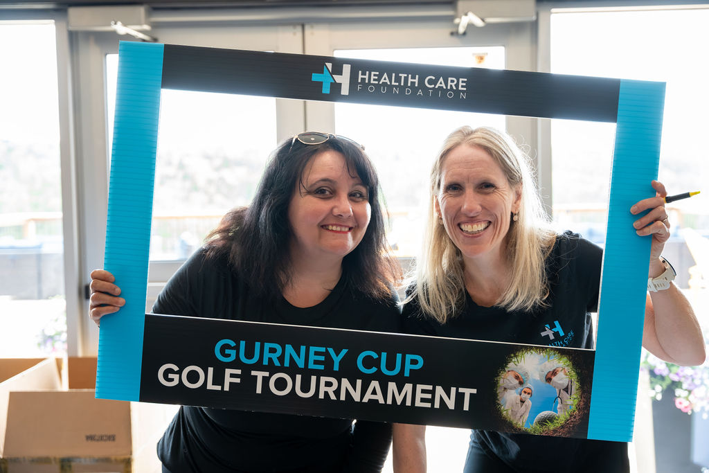 Participants posing with a photo frame at the 2026 Gurney Cup Golf Tournament