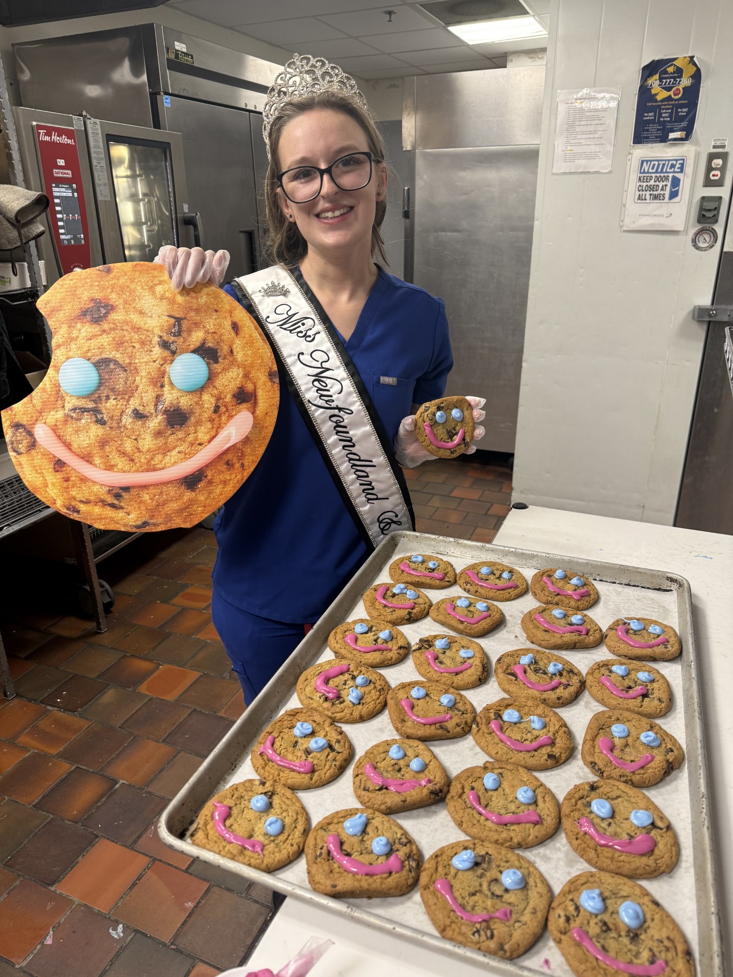 Volunteer holding a tray of freshly baked Smile Cookies