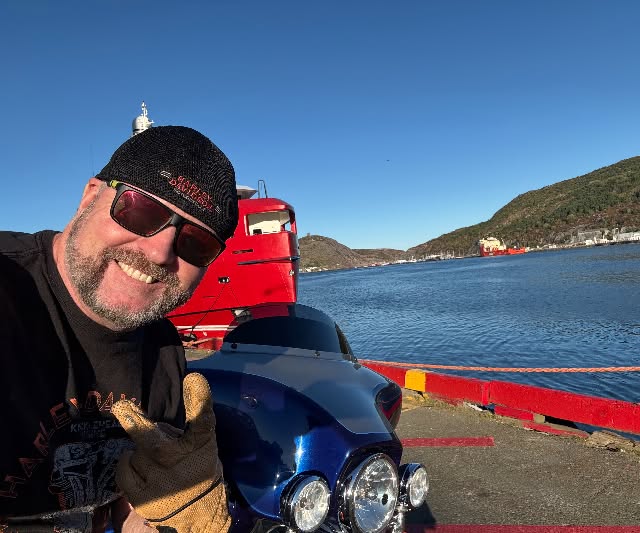 Michael Coady smiling outdoors by the water