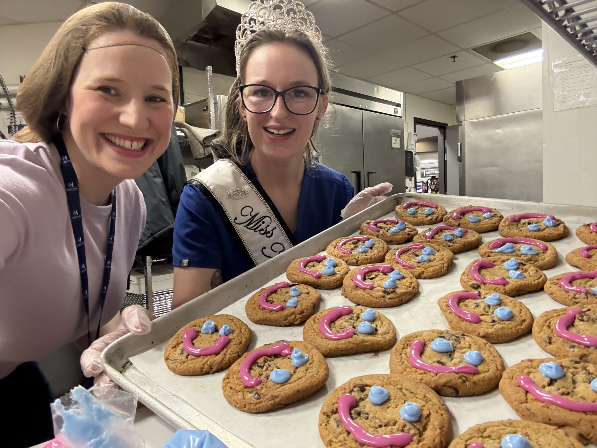 Volunteers holding a tray of Smile Cookies for a health care fundraiser