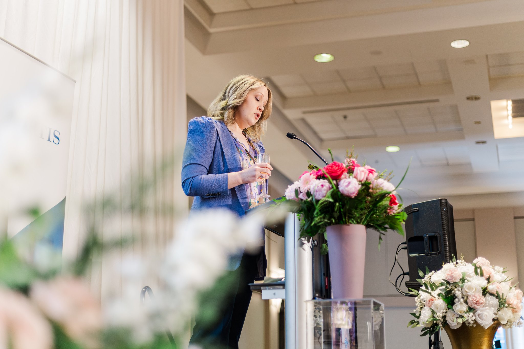 Speaker at a podium during Brunch with the Bags