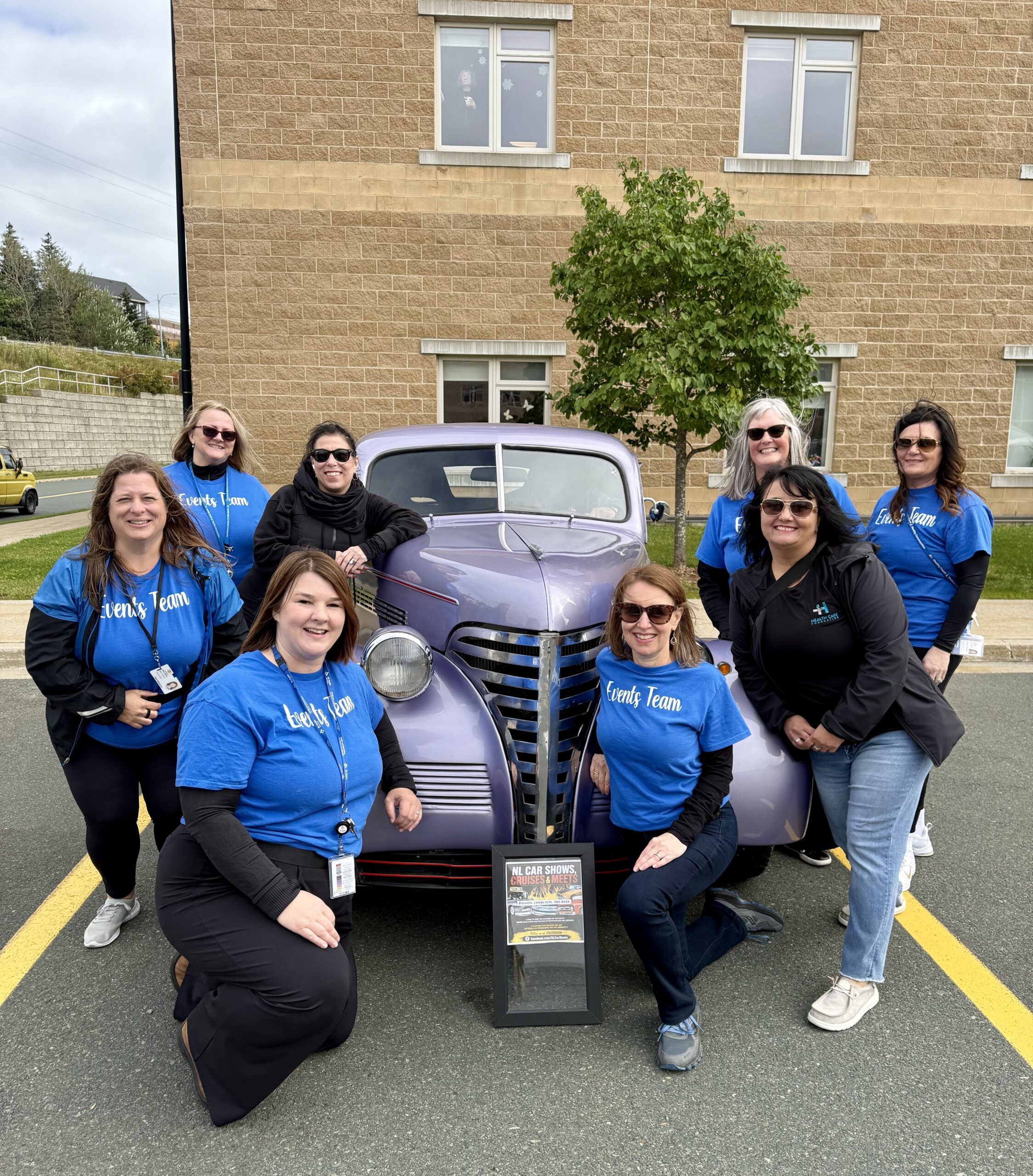 Volunteers posing with a vintage car at the Pleasant View Towers Classic Car Show, September 2026