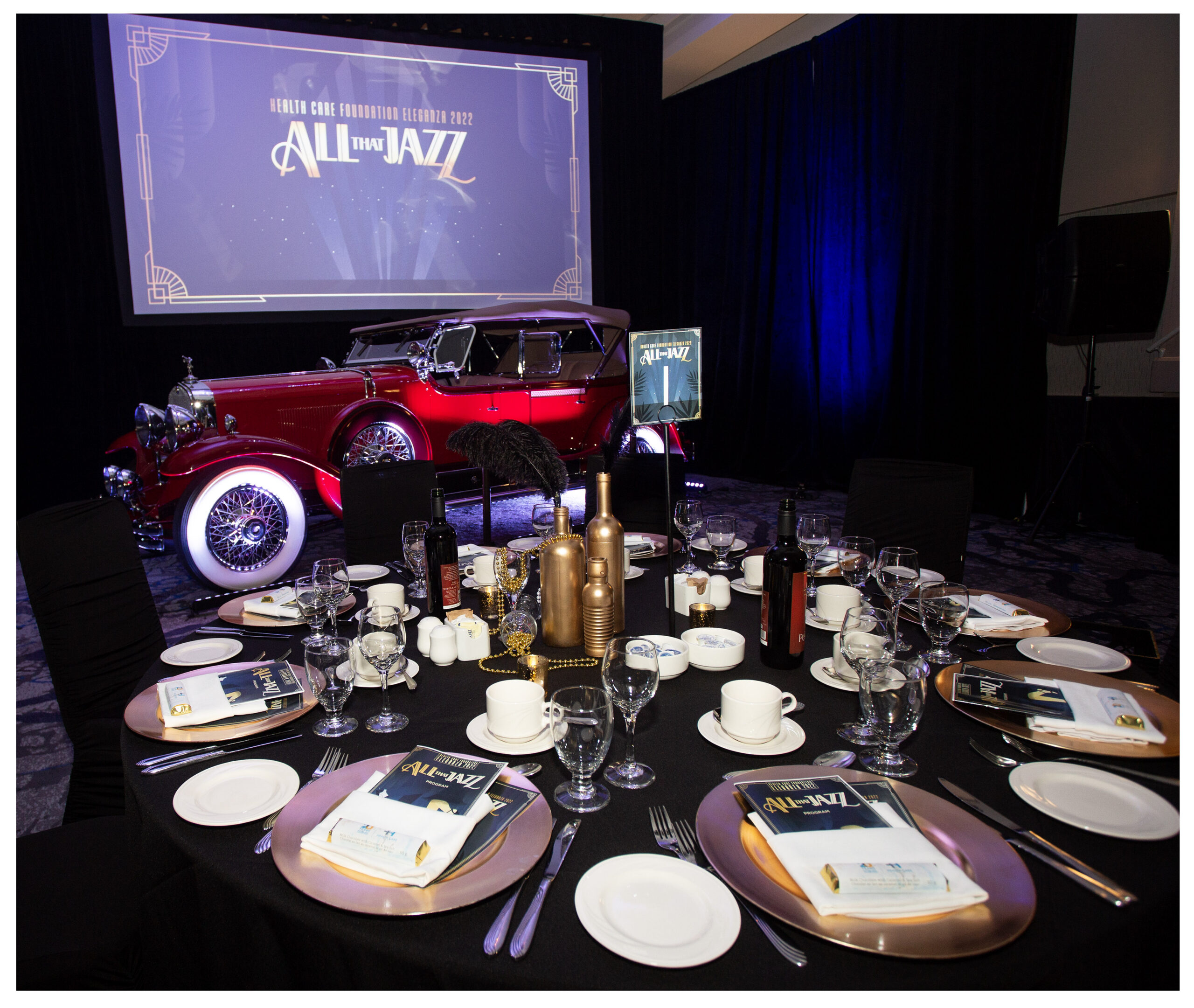 Gala dinner tables and stage at a Health Care Foundation fundraising event