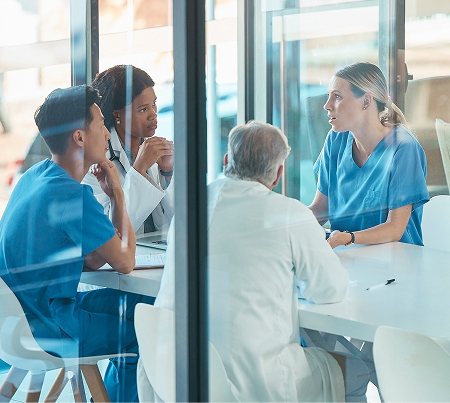 Health care professionals meeting around a table