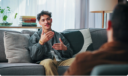 Young man talking with a counsellor in a bright room