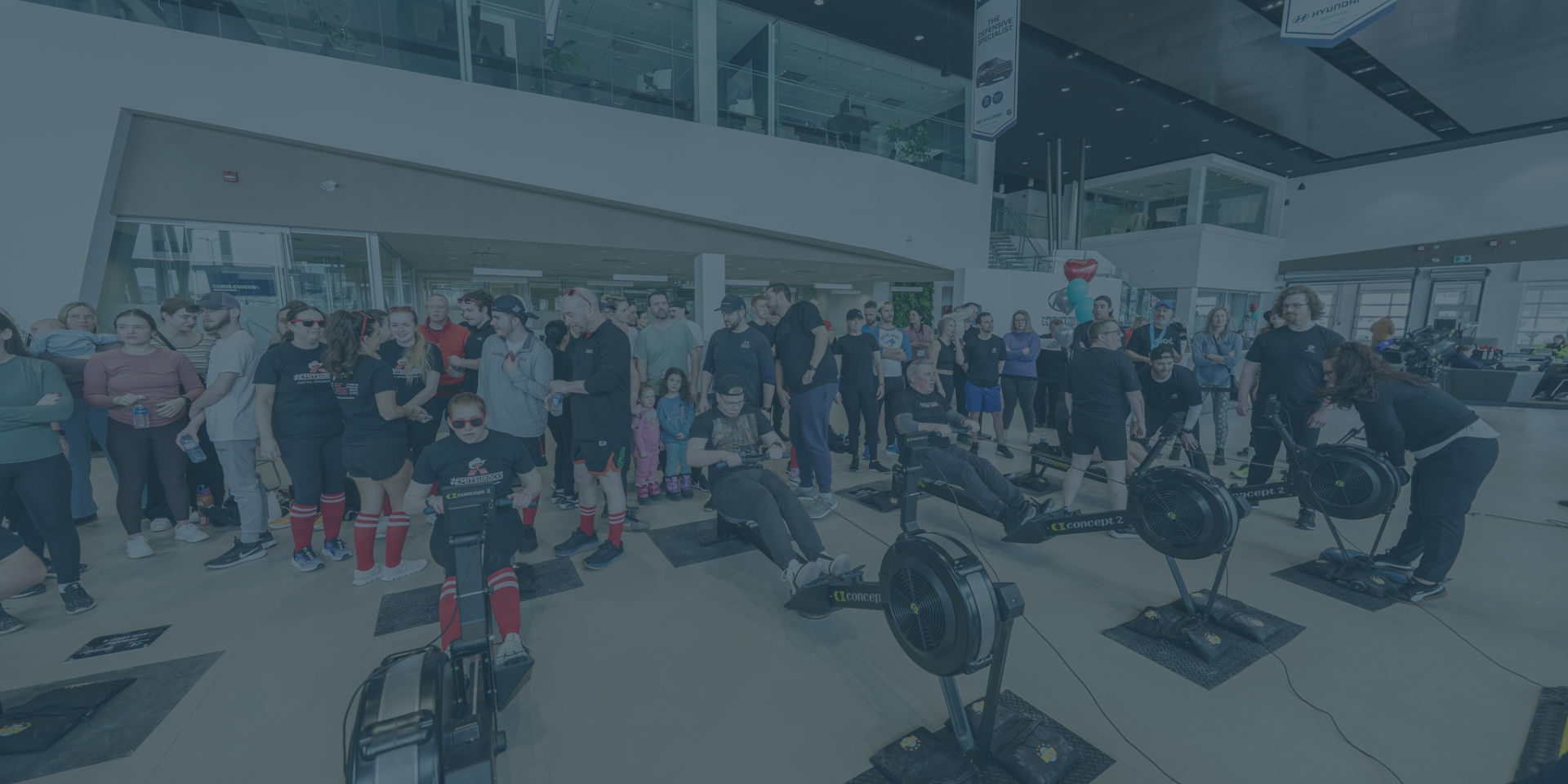 Row4Heart cardiac care fundraiser logo over event participants