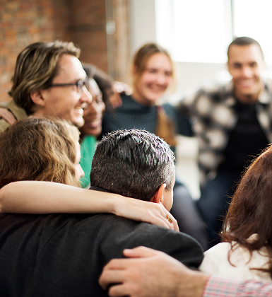 Colleagues embracing at a workplace celebration