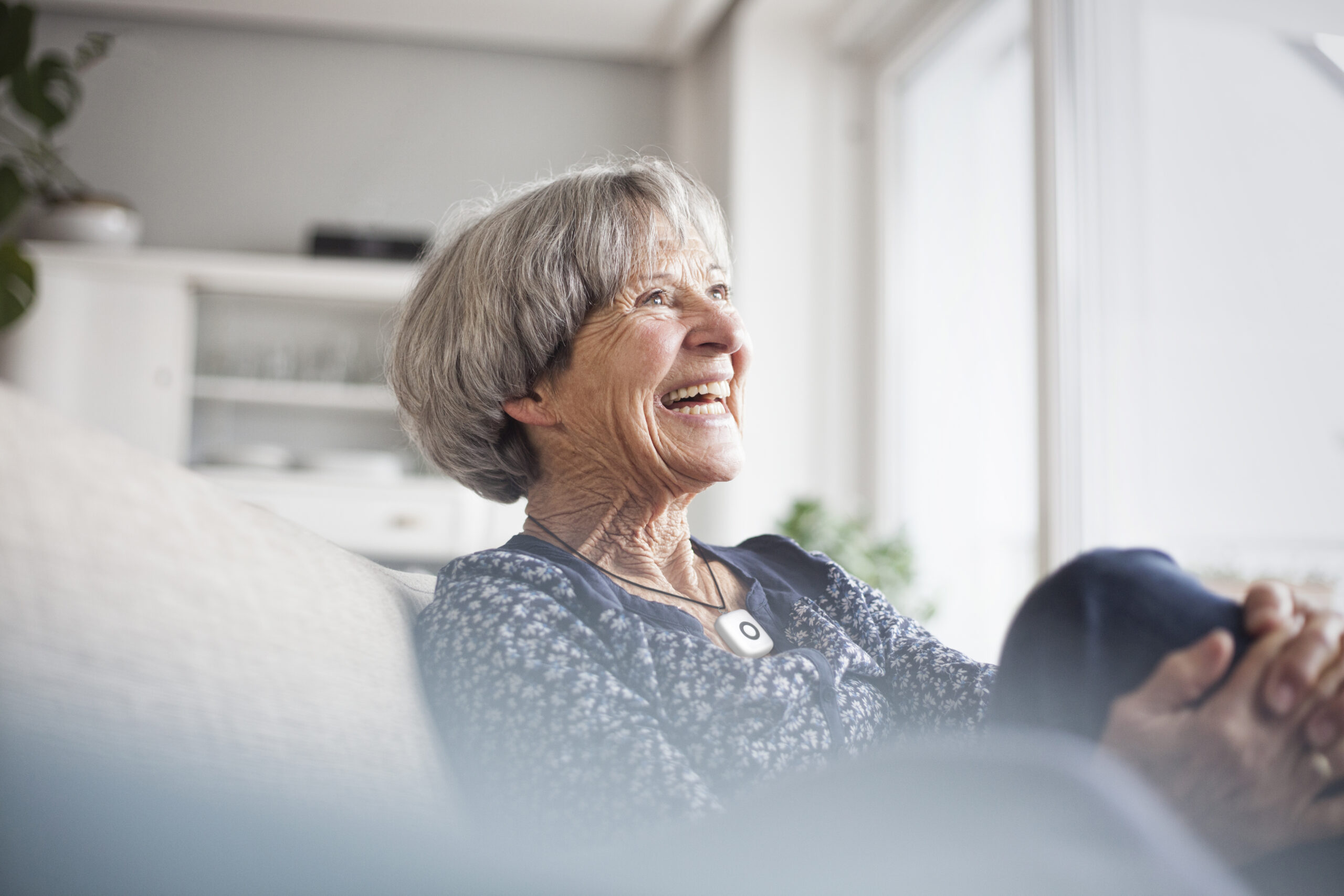 Smiling older woman relaxing on a sofa