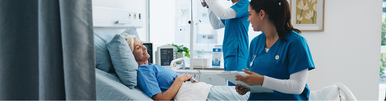 Nurse caring for a patient in a hospital bed